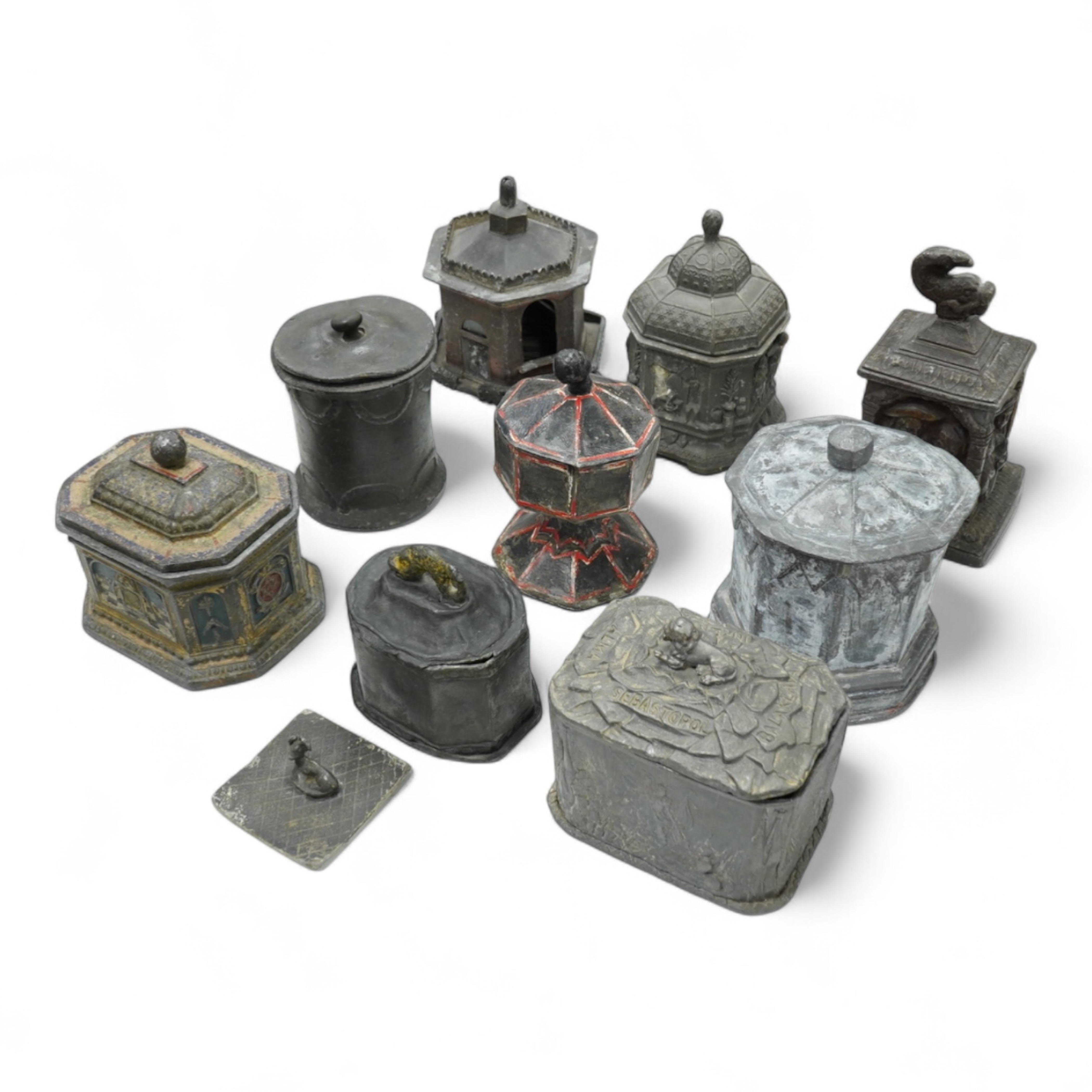 A collection of nine early 19th century lead tobacco boxes and a cover, tallest 20cm